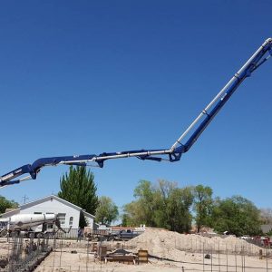 Concrete pump boom extended over rebar forest